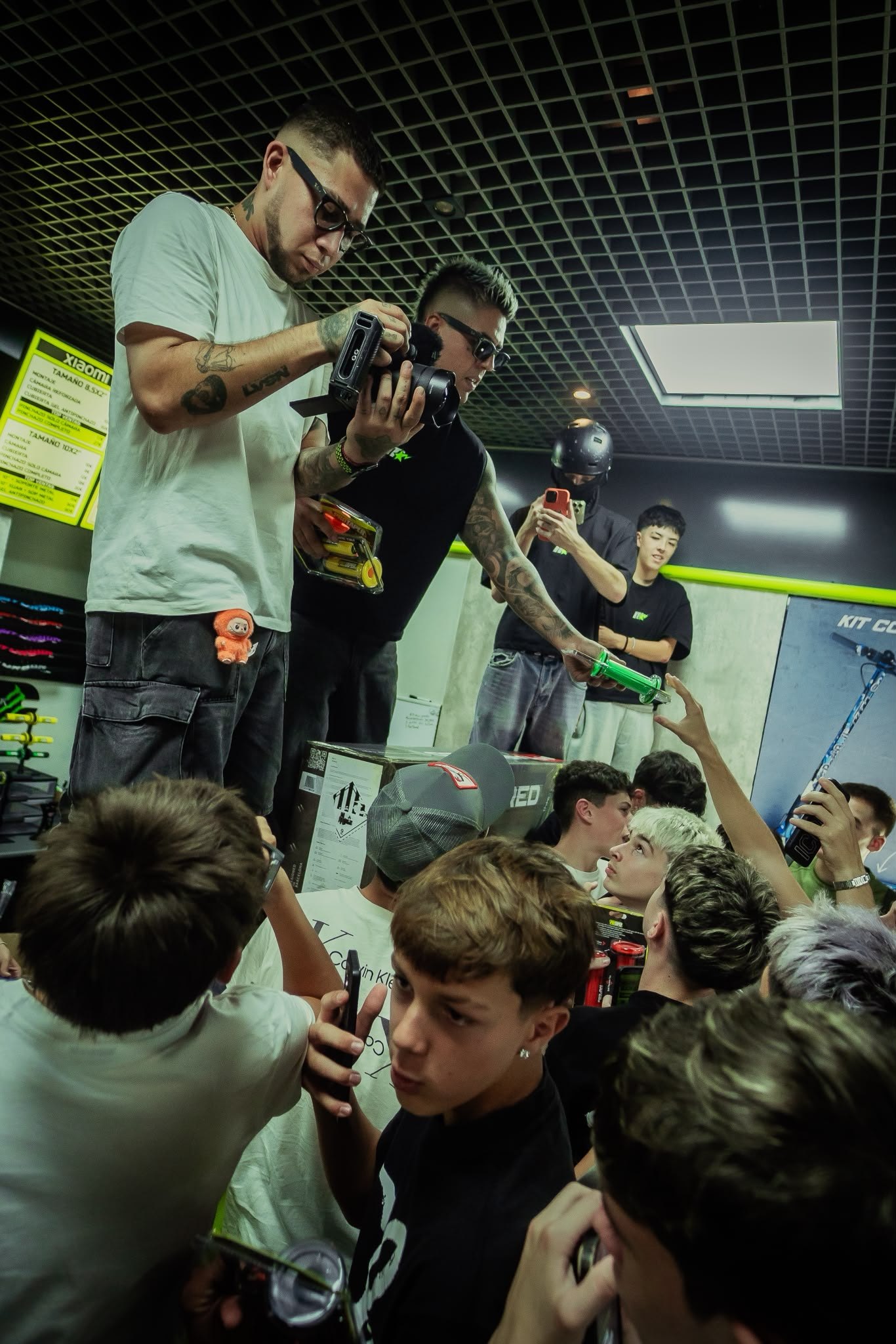 Reparto de accesorios para patinete a los asistentes durante el sorteo en la tienda de Valencia